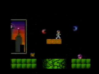 A screenshot of gameplay. Captain Pixel stands on a floating platform in the center of the screen. Whirling red and blue fire enemies fly to his left and right. Below, a frog-like enemy and a Goomba-like enemy traverse a floor broken by pits. The background is black, except for a portion of a window looking out at a crepuscular cityscape.